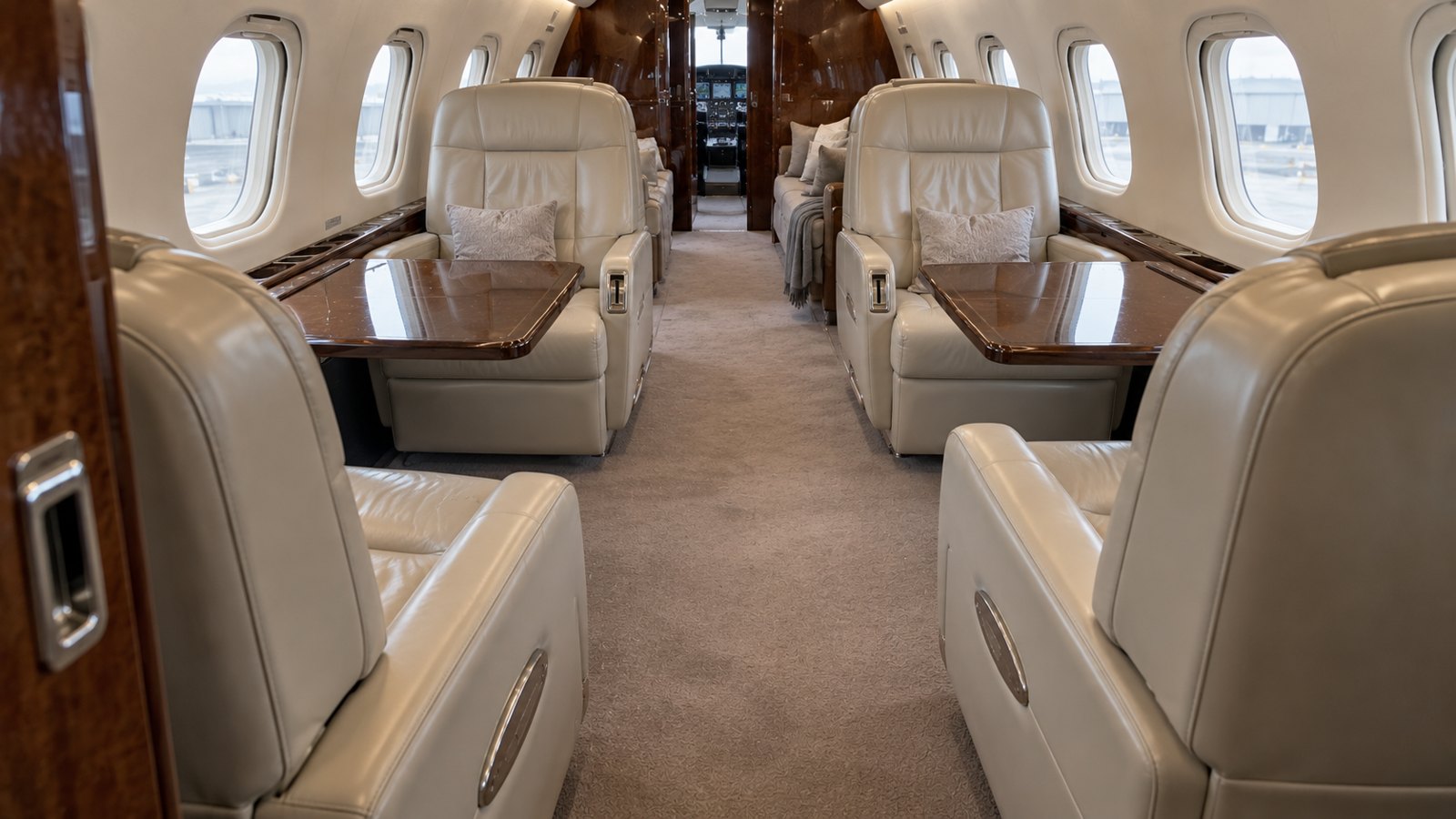Clean private jet cabin example viewed from the opposite end with cleared tables and refreshed seats and carpet